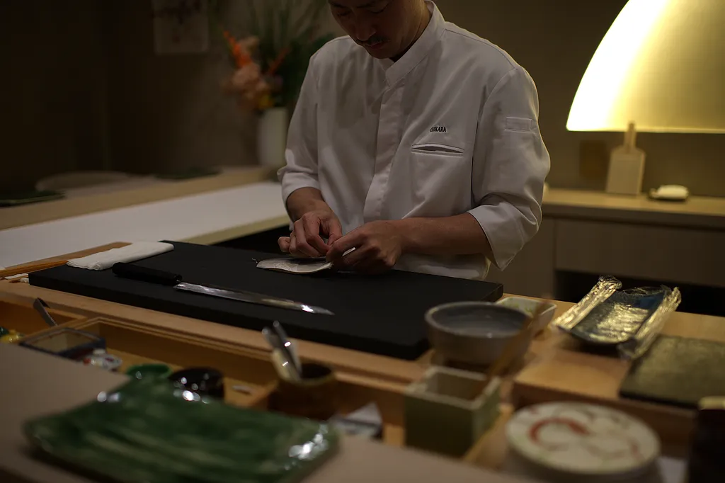 The chef's hands forming a piece of nigiri