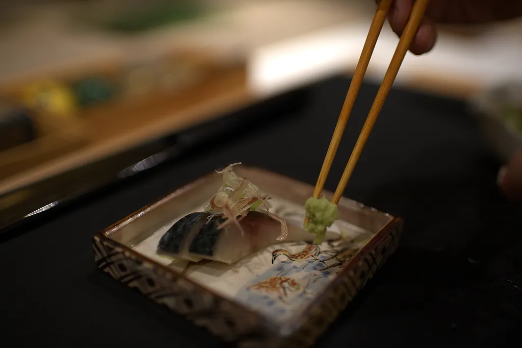 A course arranged on a lacquered tray with chopsticks