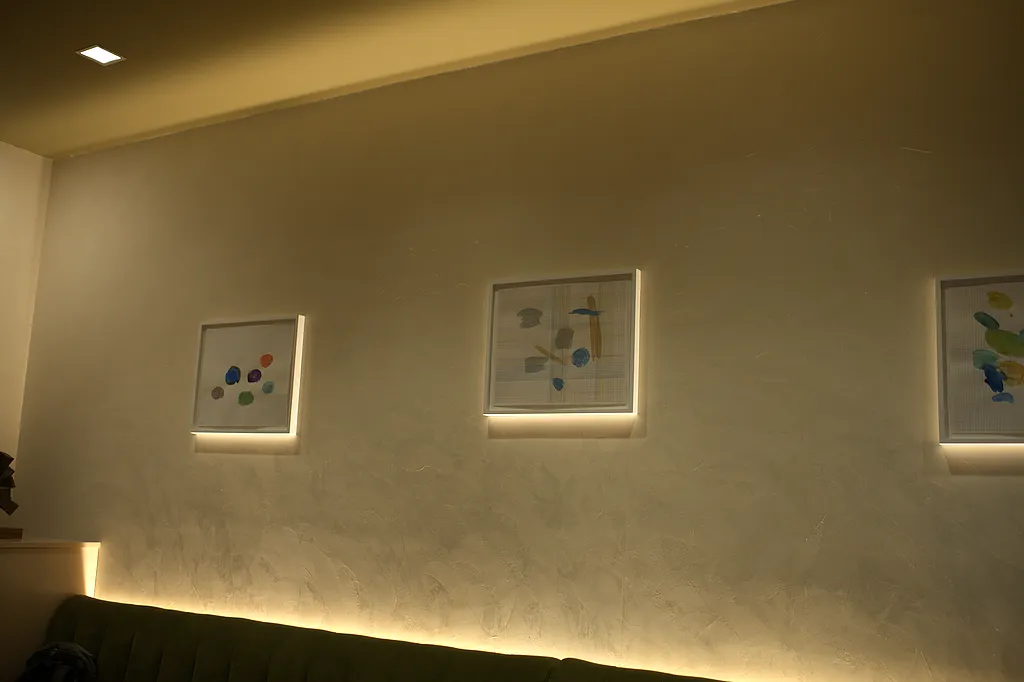 The banquette beneath the dining room's framed works