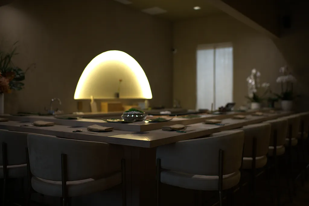 The lit counter at Chikara beneath its arched light