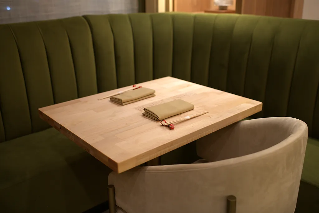 A chair pulled back from a hinoki table